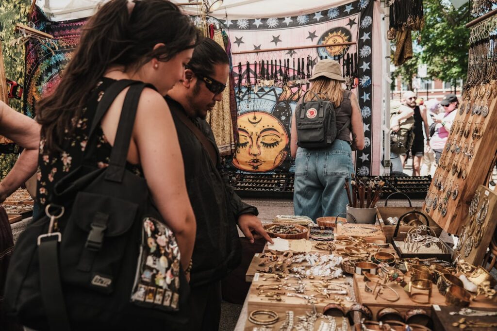 People Looking at Jewelry Stalls at a Market